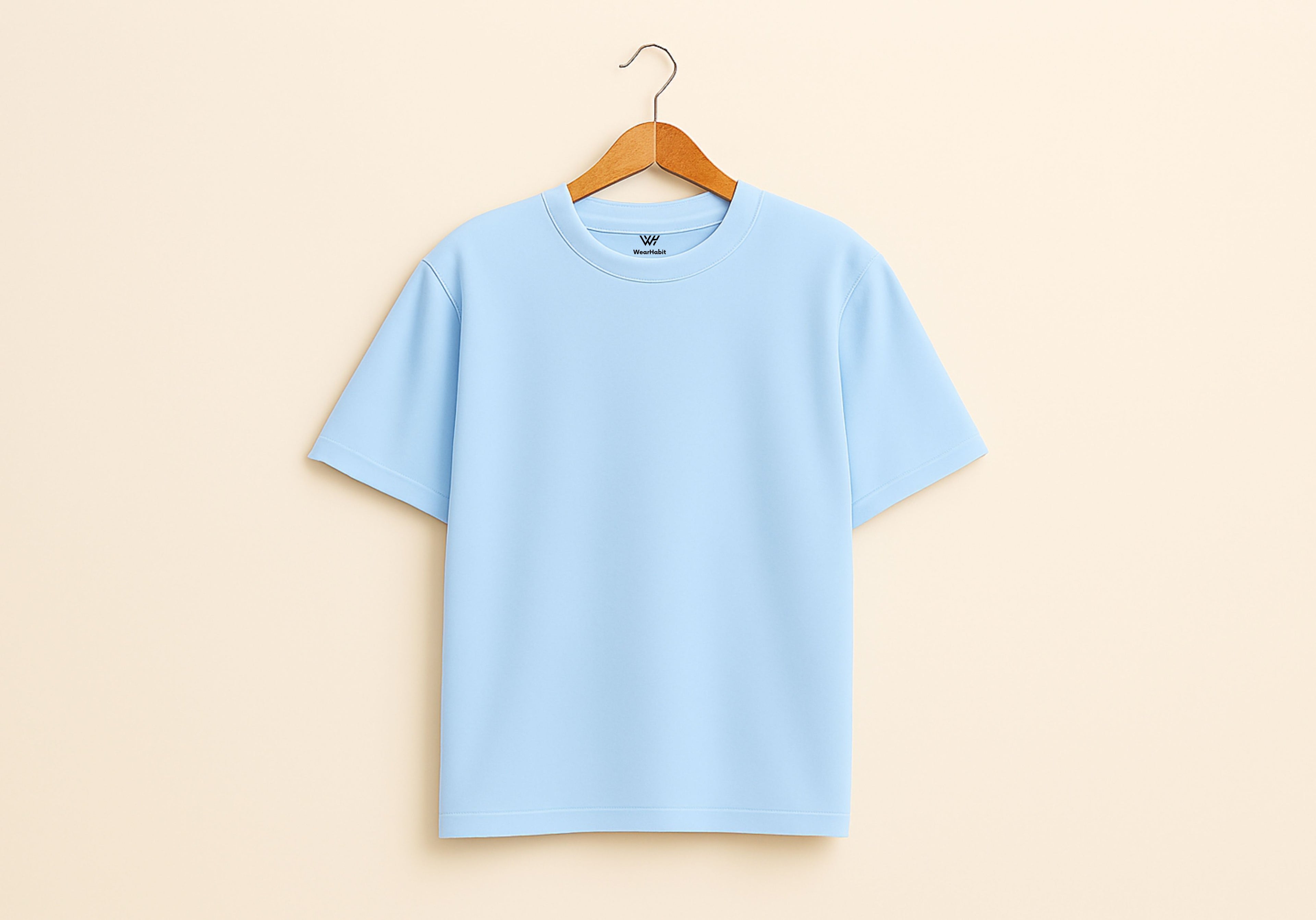 Mint color  t-shirt on a wooden hanger against a beige background