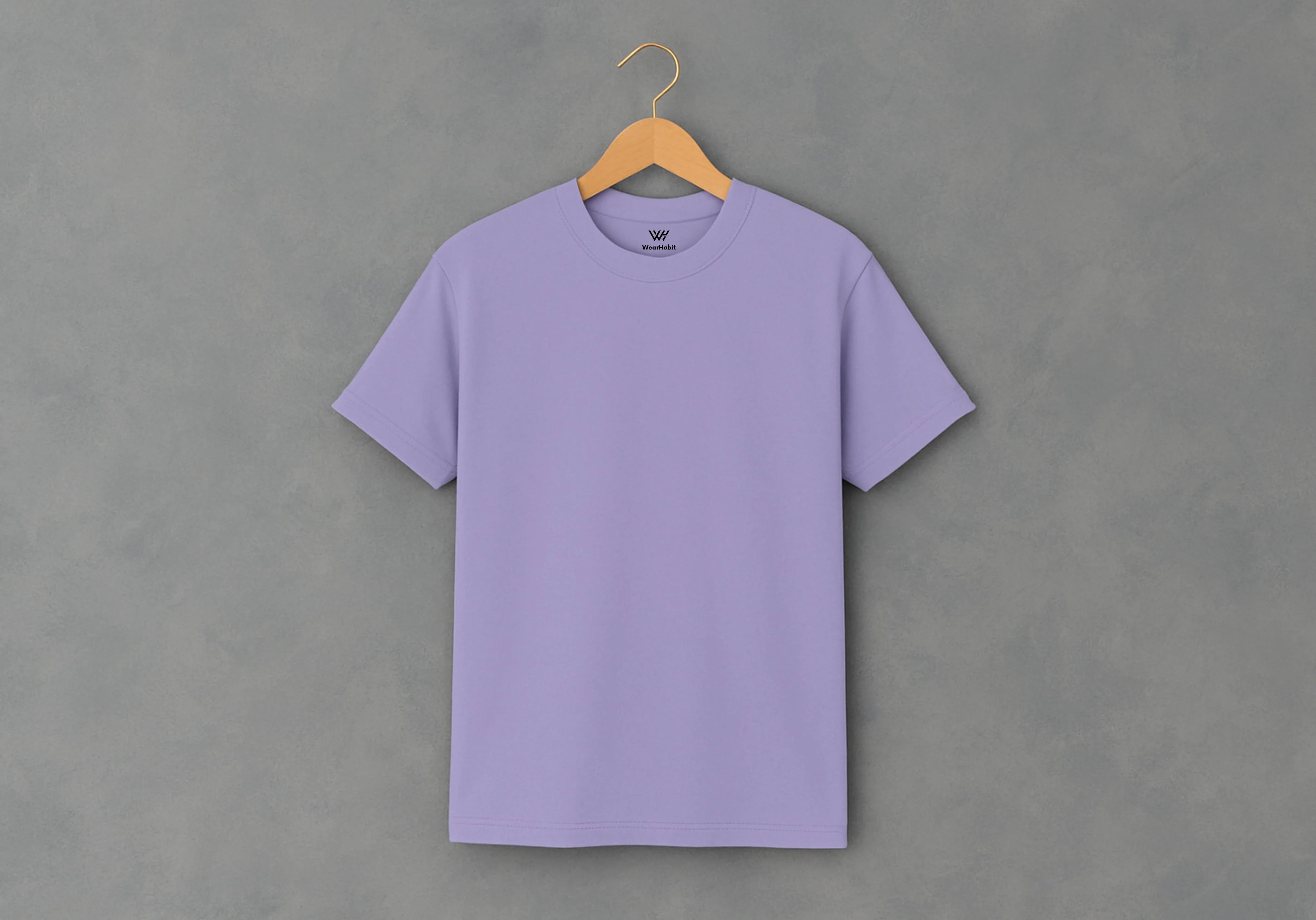 Purple t-shirt on a wooden hanger against a gray background