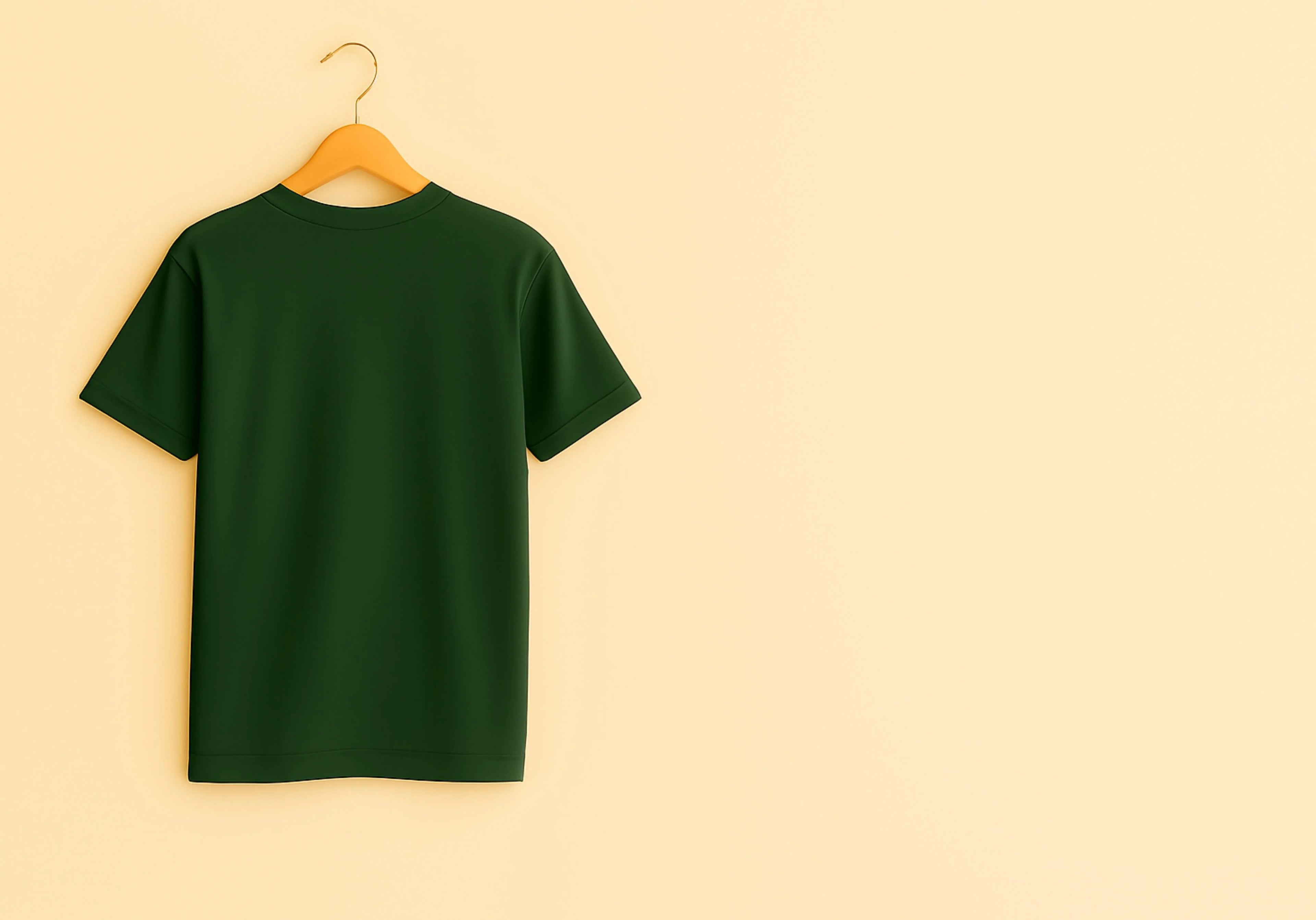 Green t-shirt on a wooden hanger against a beige background
