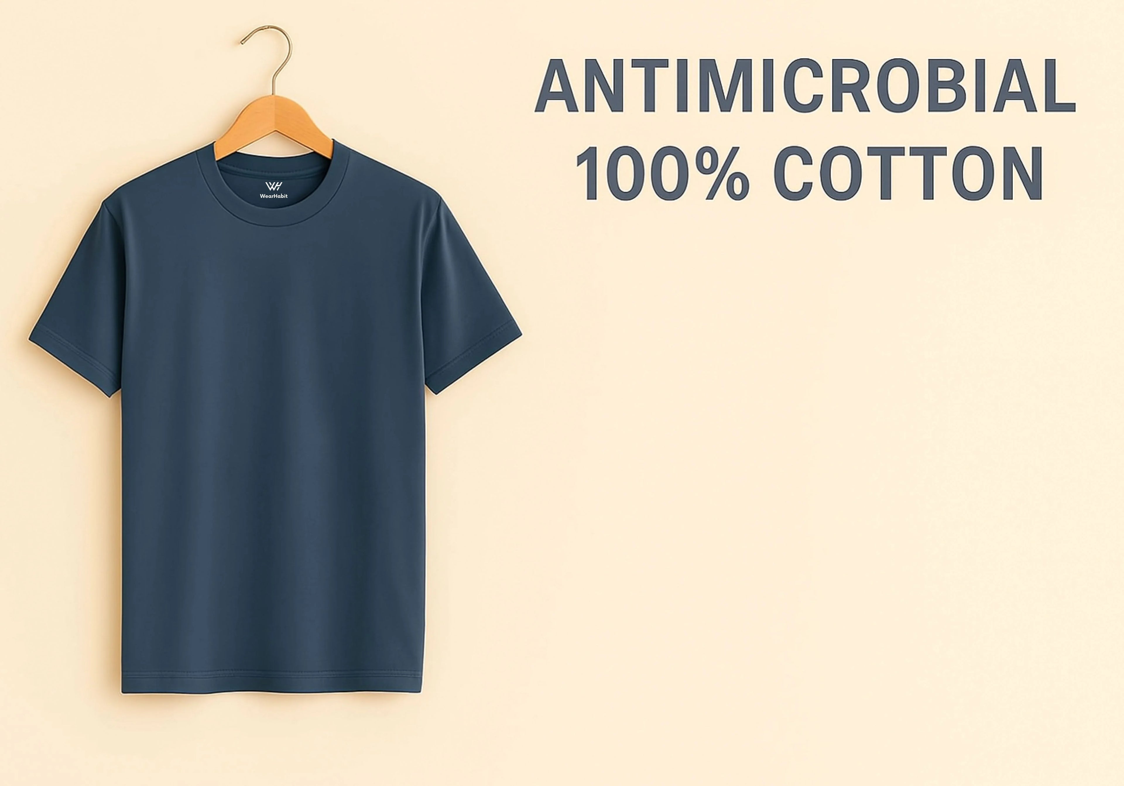 Navy blue t-shirt on a hanger with 'Antimicrobial 100% Cotton' text on a beige background