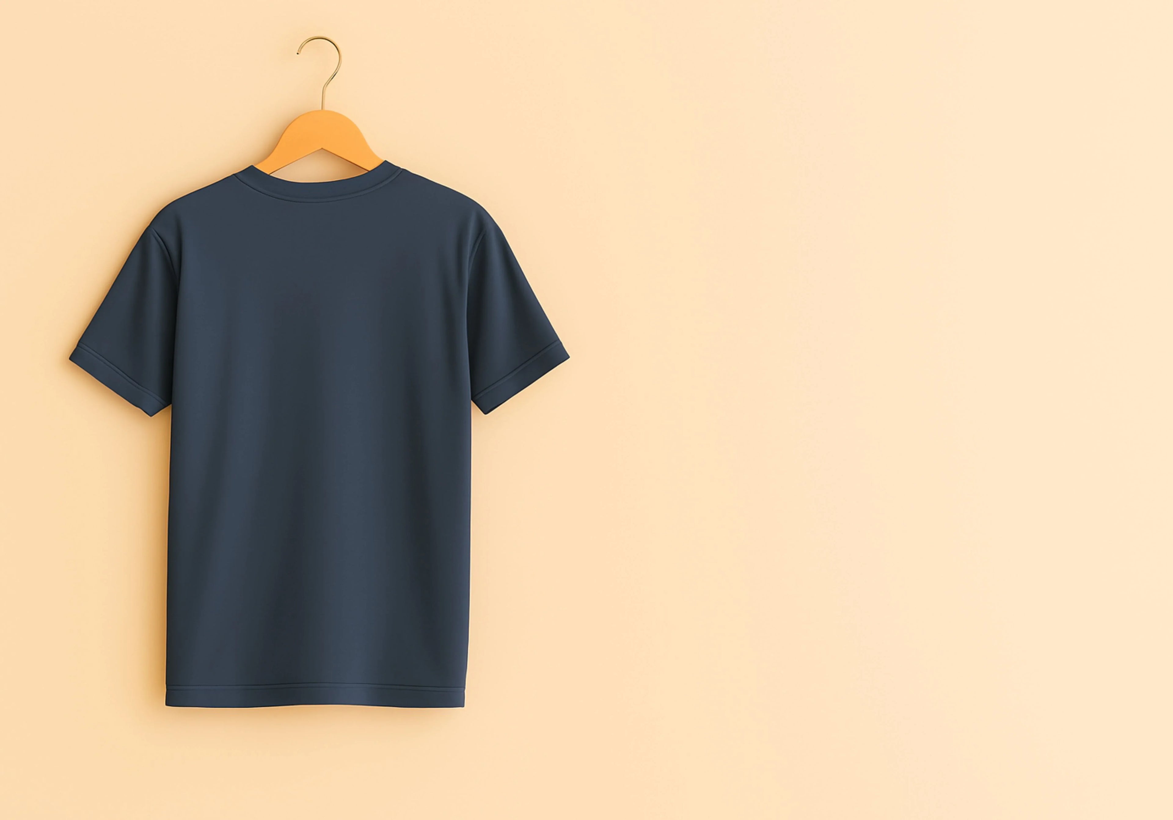 Navy blue t-shirt on a wooden hanger against a beige background