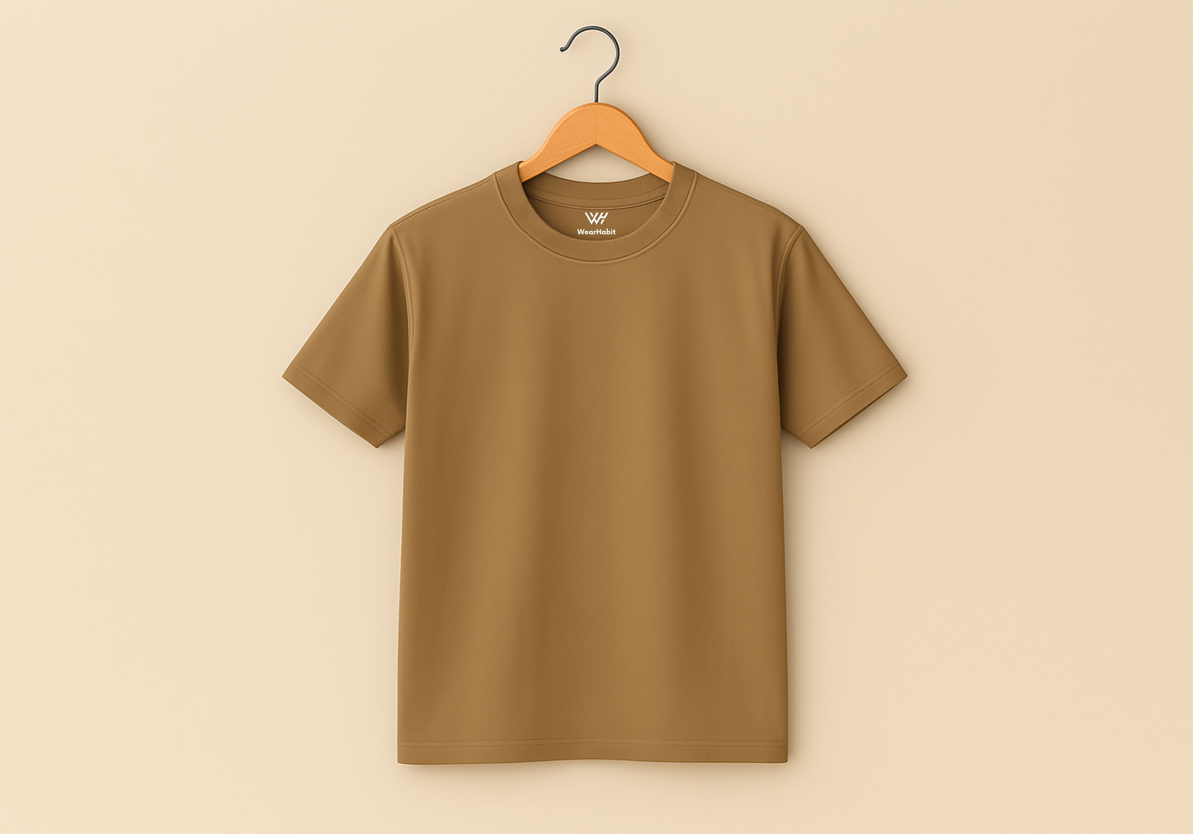 Brown t-shirt on a wooden hanger against a beige background