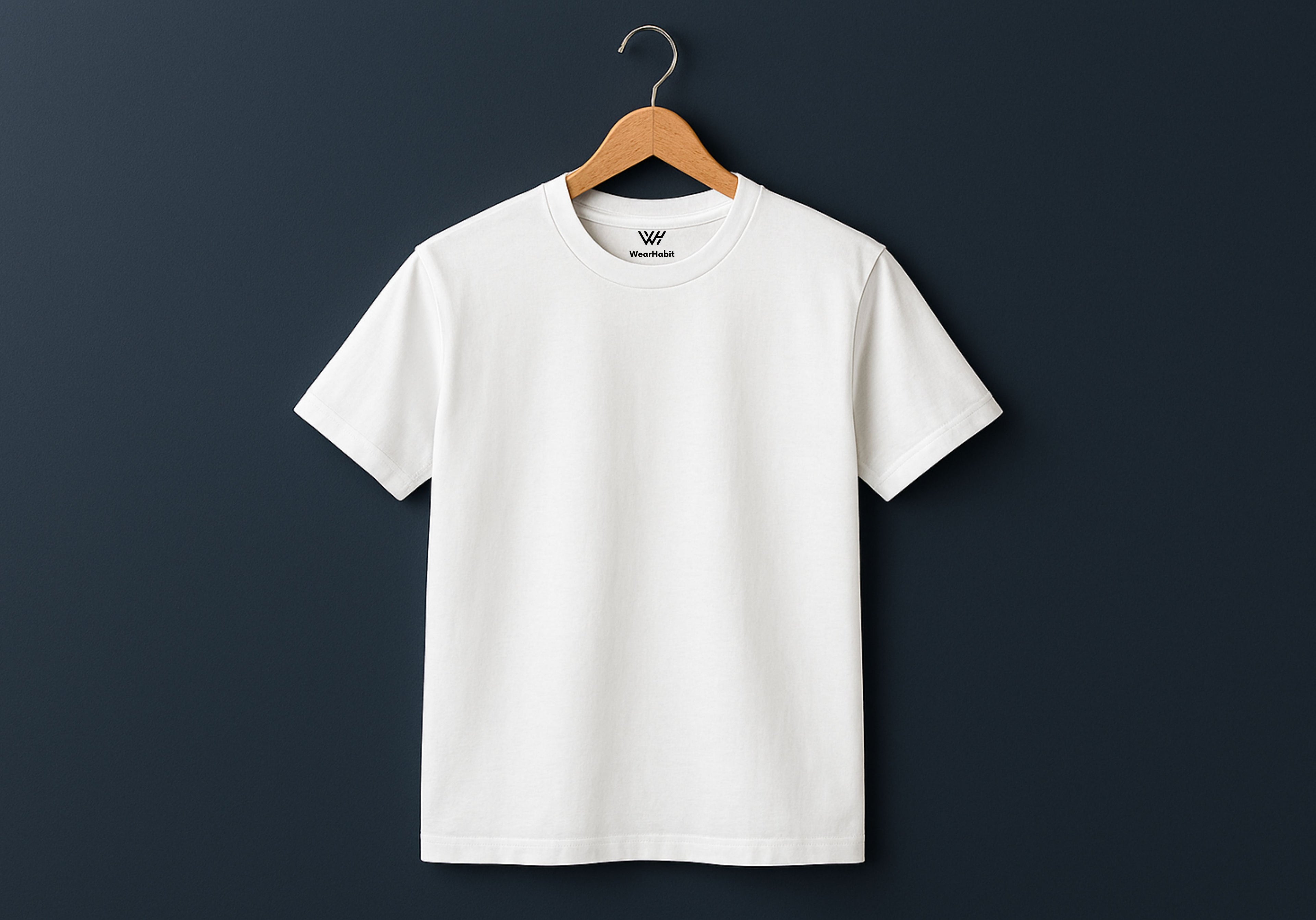 White t-shirt on a wooden hanger against a dark background