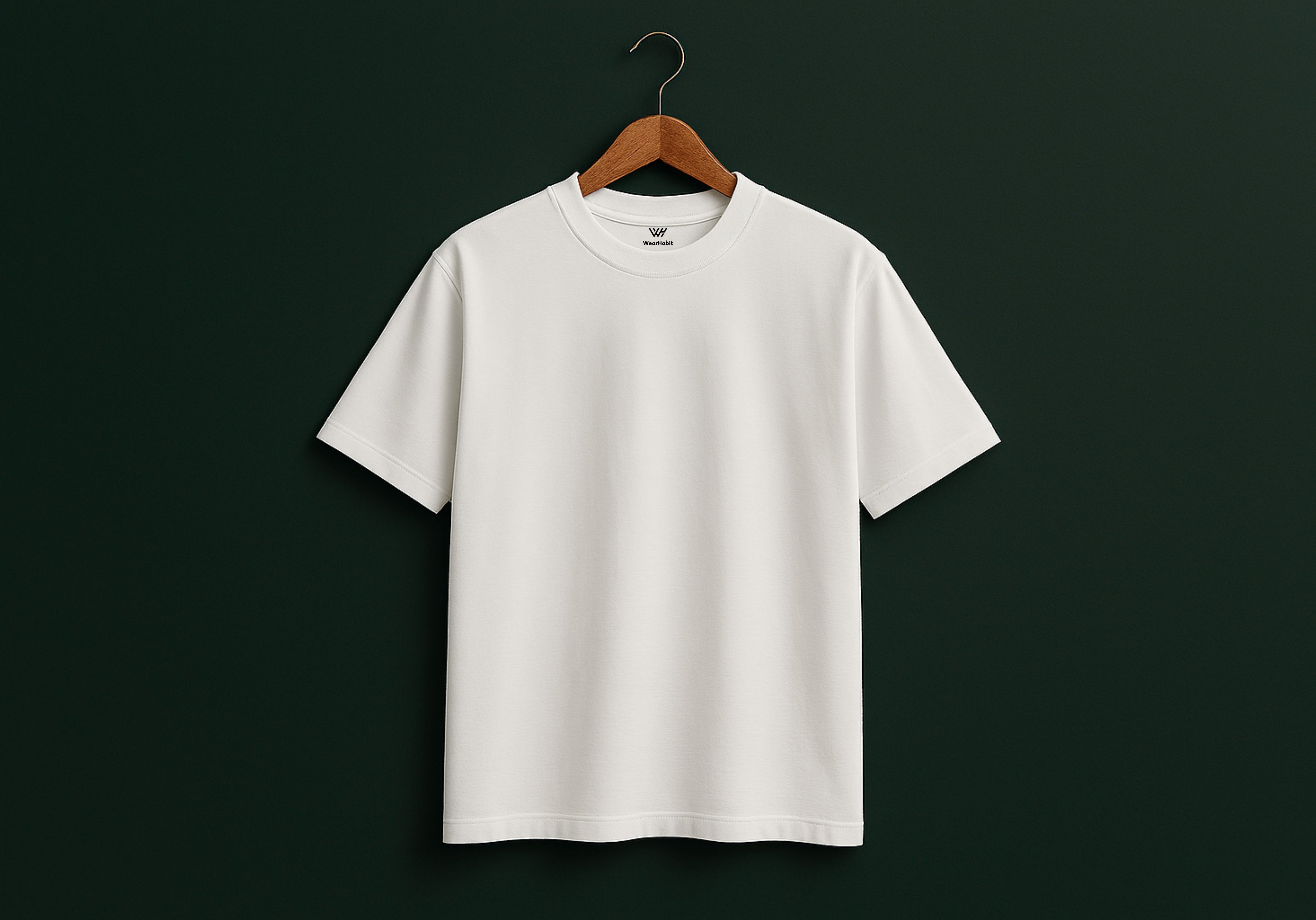 White t-shirt on a wooden hanger against a black background