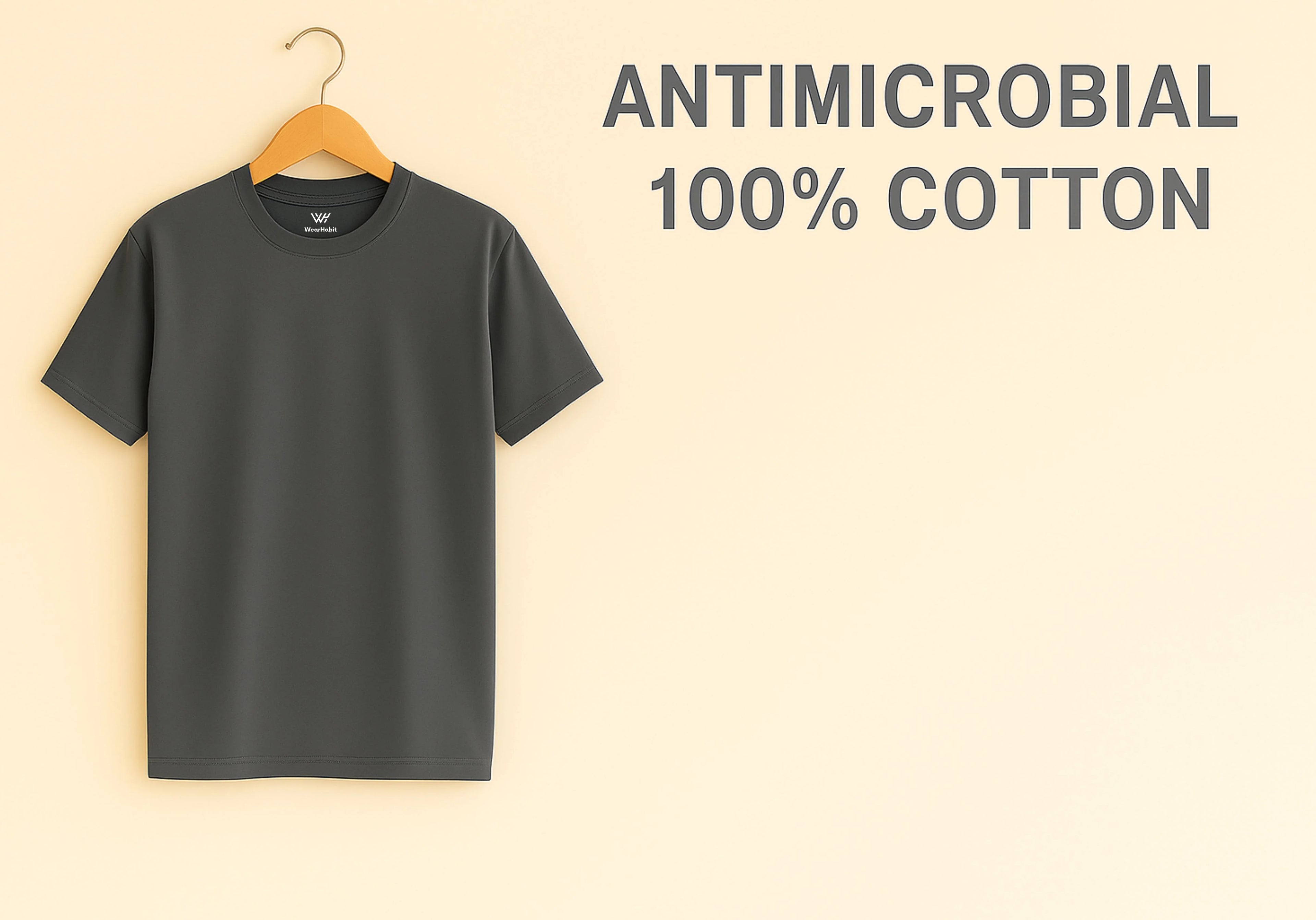 Black t-shirt on a hanger with 'Antimicrobial 100% Cotton' text on a beige background