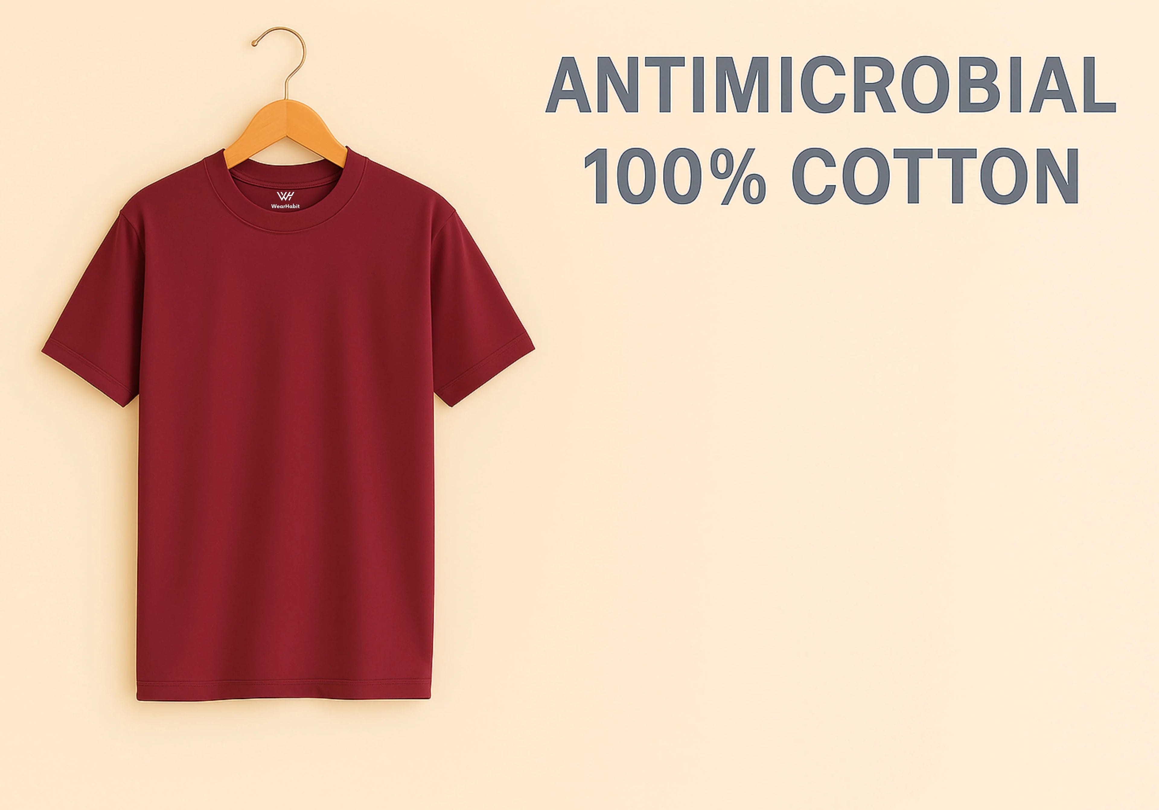 Maroon t-shirt on a hanger with 'Antimicrobial 100% Cotton' text on a beige background