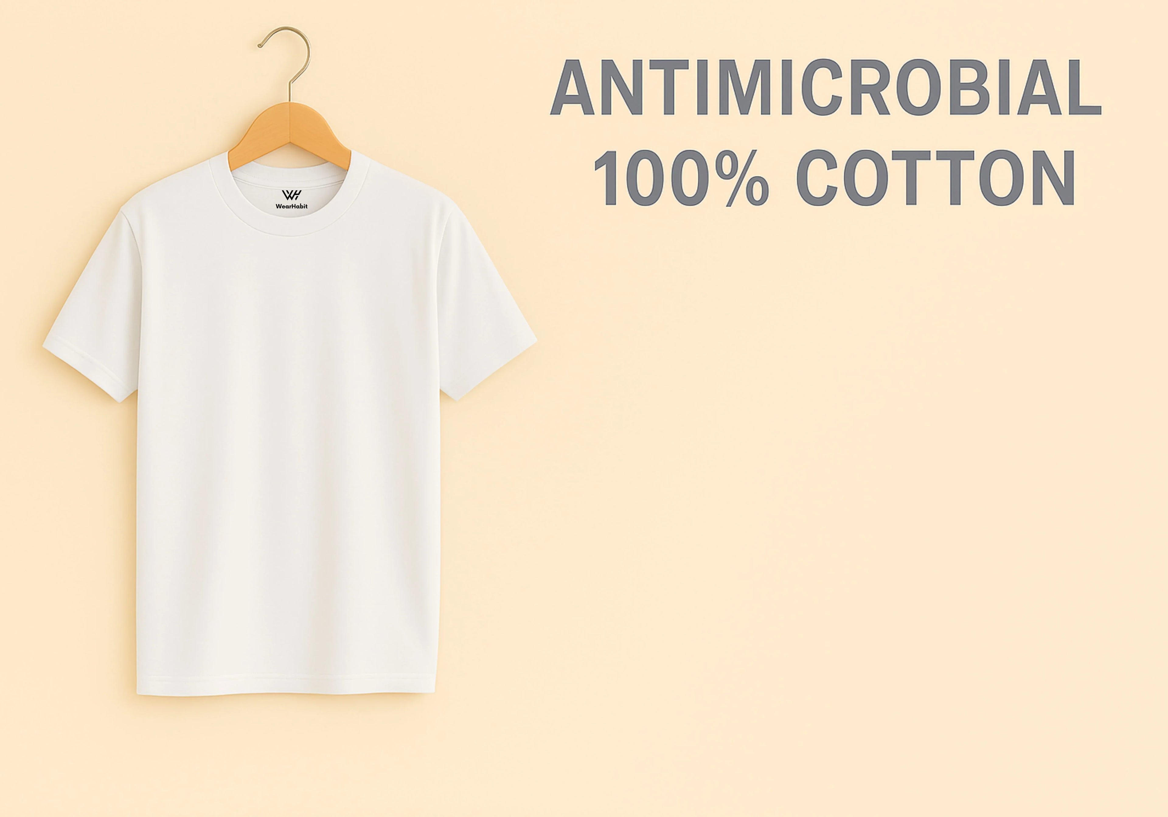 White t-shirt on a hanger with 'ANTIMICROBIAL 100% COTTON' text on a beige background