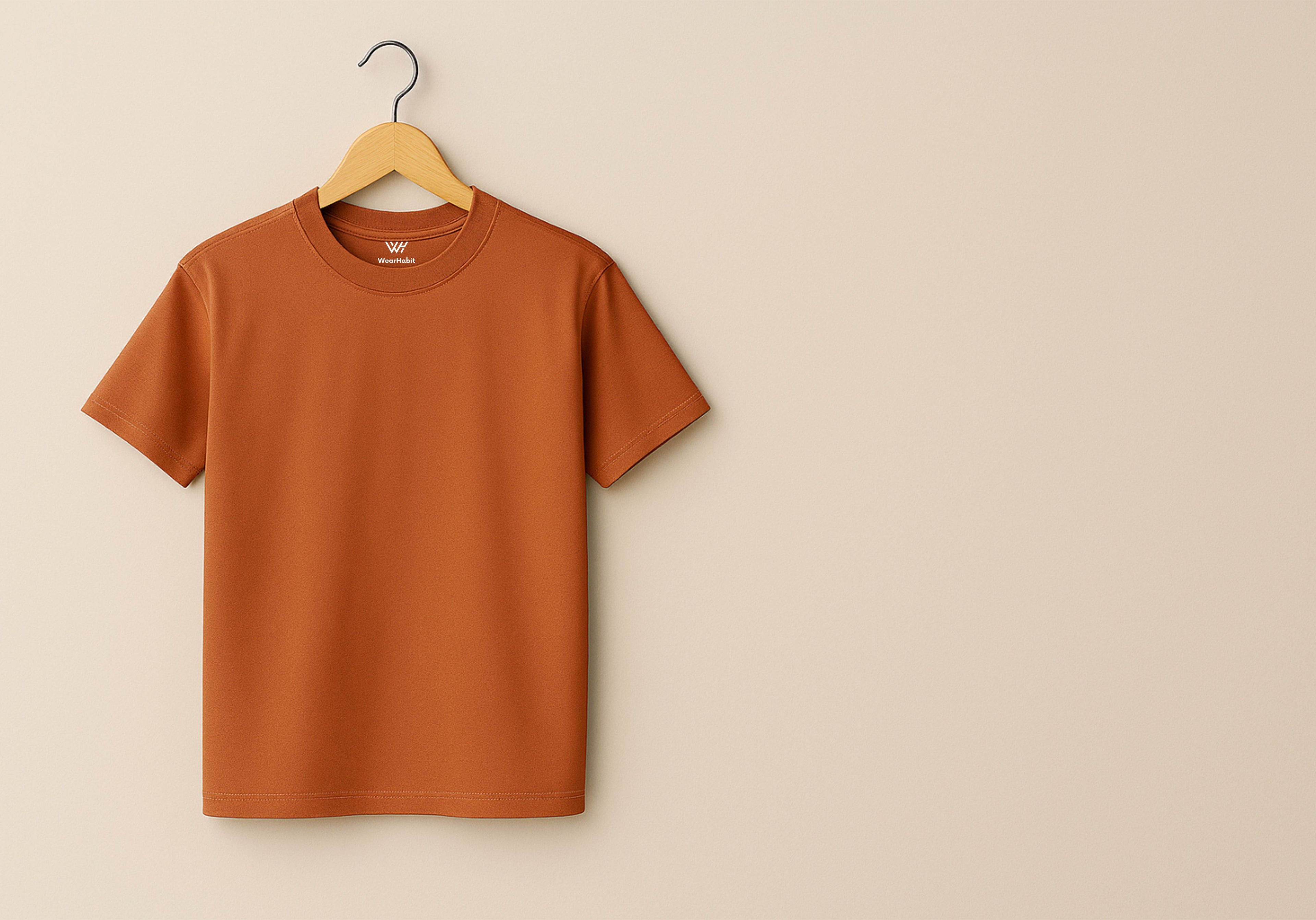 Copper t-shirt on a wooden hanger against a beige background